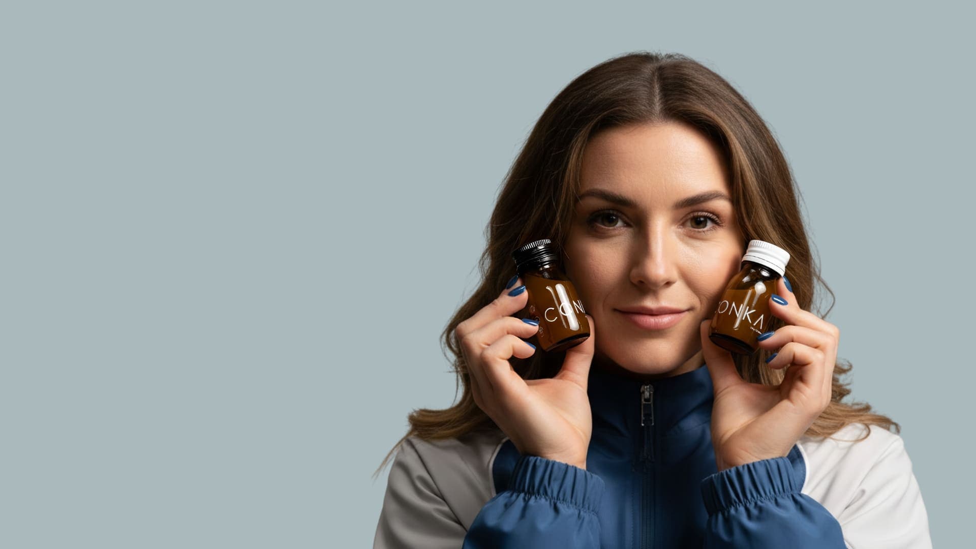 Athlete holding CONKA Flow and Clear bottles
