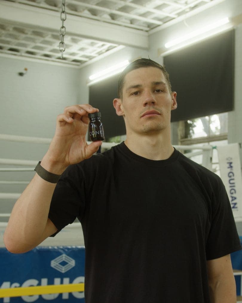A CONKA athlete holding the daily shot