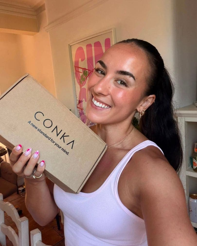 A CONKA customer holding their delivery box