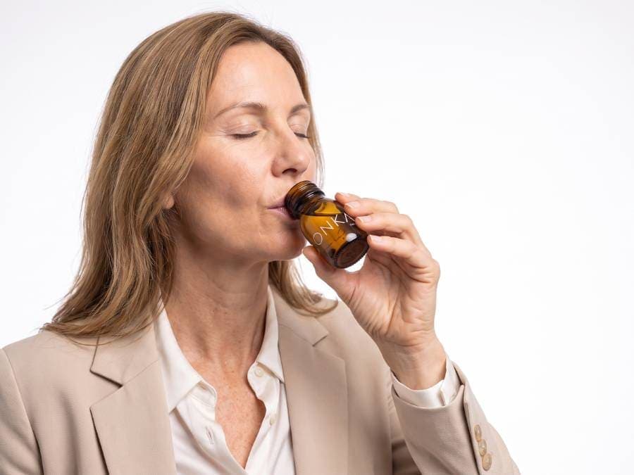 A professional woman in her fifties taking a CONKA shot